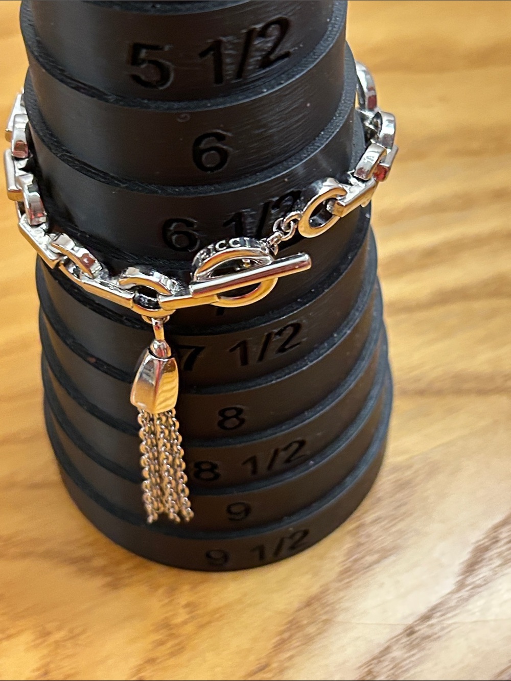 Nina Ricci Silver Chain Bracelet with Tassel Toggle